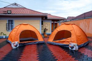 two tents are set up in front of a house at Happy Trails Home- Nanyuki in Nanyuki