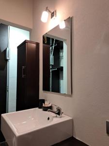 a bathroom with a sink and a mirror at La Casa Del Podestà 65 in Florence