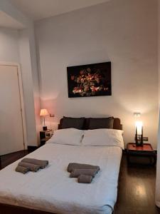 a bedroom with a large bed with two pillows on it at La Casa Del Podestà 65 in Florence