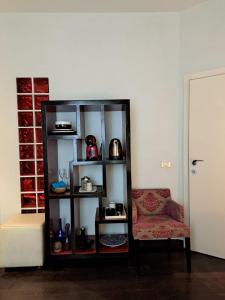 a room with a book shelf and a chair at La Casa Del Podestà 65 in Florence +18 photos
