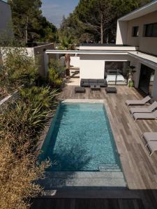 a swimming pool in the backyard of a house at Villa Yuna Heated Swimming Pool Beach in Cap d'Agde