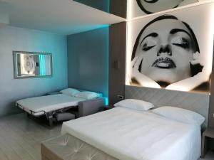 Postel nebo postele na pokoji v ubytování Hotel Camelia