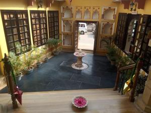 an entrance to a building with potted plants at Janki Vilas in Orchha