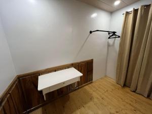 a room with a white desk and a curtain at Condo in Green Valley Baguio in Baguio