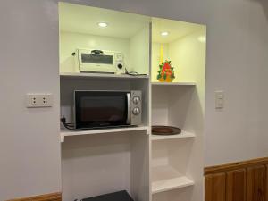 a kitchen with a microwave and a toaster oven at Condo in Green Valley Baguio in Baguio