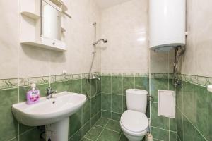 a bathroom with a toilet and a sink at Sea&Park Apartment by Linas BNB in Varna City +11 photos