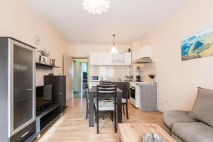 a kitchen and living room with a table and chairs at Sea&Park Apartment by Linas BNB in Varna City