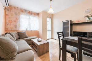 a living room with a couch and a table at Sea&Park Apartment by Linas BNB in Varna City