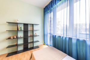 a bedroom with a book shelf and a bed at Sea&Park Apartment by Linas BNB in Varna City