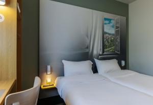 Postel nebo postele na pokoji v ubytování B&B HOTEL Freyming-Merlebach