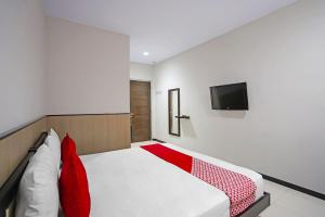 Voodi või voodid majutusasutuse OYO 91710 Hotel Anugerah toas