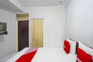 Voodi või voodid majutusasutuse OYO 91710 Hotel Anugerah toas