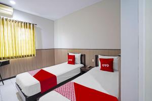 Voodi või voodid majutusasutuse OYO 91710 Hotel Anugerah toas