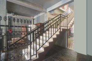 a staircase in a house with a wrought iron railing at Hotel O Priska Kost Dan Homestay in Manado +19 photos