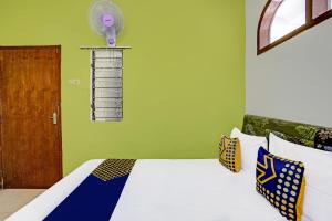 a bedroom with a bed with a fan on the wall at SPOT ON 91716 Kost Yy Syariah in Mojokerto +30 photos