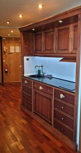 a kitchen with a sink and wooden cabinets at Apartamento Vacacional El Rompido in El Rompido