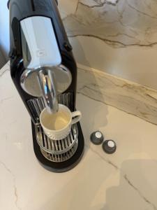 a hair dryer sitting on a counter with a cup at Duplex sur le Golfe de Saint Tropez - Panoramic View in Cogolin