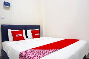Postel nebo postele na pokoji v ubytování Super OYO Capital O 91790 S1 Residence