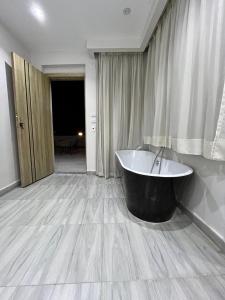 a bathroom with a bath tub in a room at Pyramid hotel in Cairo +41 photos