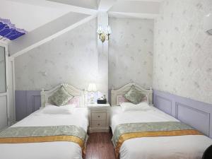 Un ou plusieurs lits dans un hébergement de l'établissement Gulangyu Yuanzhongyuan Homestay