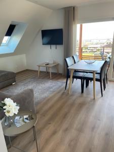 a living room with a table and a couch at La Clé des Vignes 2 in Ribeauvillé