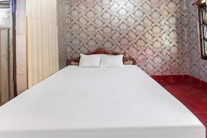 Postel nebo postele na pokoji v ubytování OYO 91829 Hotel Artha