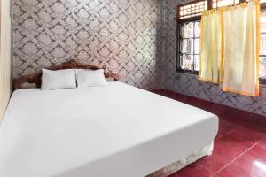 Postel nebo postele na pokoji v ubytování OYO 91829 Hotel Artha