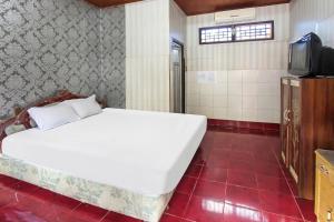 Postel nebo postele na pokoji v ubytování OYO 91829 Hotel Artha