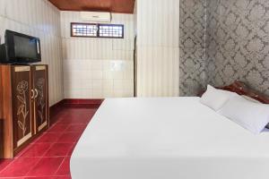 Postel nebo postele na pokoji v ubytování OYO 91829 Hotel Artha