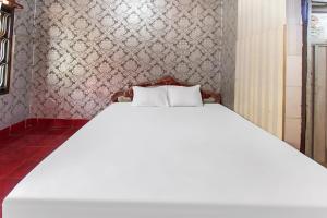 Postel nebo postele na pokoji v ubytování OYO 91829 Hotel Artha