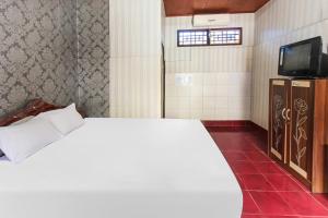 Postel nebo postele na pokoji v ubytování OYO 91829 Hotel Artha