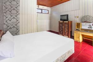 Postel nebo postele na pokoji v ubytování OYO 91829 Hotel Artha