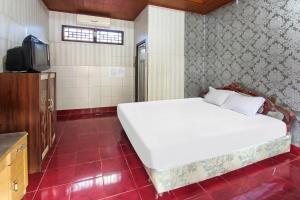 Postel nebo postele na pokoji v ubytování OYO 91829 Hotel Artha