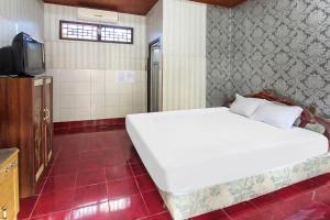 Postel nebo postele na pokoji v ubytování OYO 91829 Hotel Artha + 19 fotografií