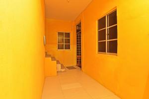 an orange hallway with stairs and a window at Capital O 90664 Rabi Hotel in Kota Bharu