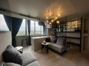 a living room with a couch and a table at Mondden Penthouse Apartaments in Chişinău