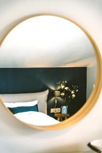a bedroom with a bed and a round mirror at Spacious boutique family apt w sunny balcony & mountain views in Zell am See +42 photos