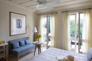 a bedroom with a bed and a blue couch at Anassa in Polis Chrysochous
