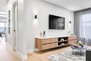 a living room with a tv on a wall at Sunbury Luxury - The Perfect Family Entertainer in Sunbury