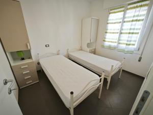 a hospital room with two beds and a window at Patrizia in Rosolina