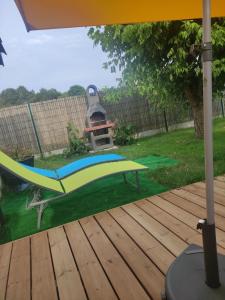 a backyard with a hammock on a deck at La Perlilounette in Le Porge