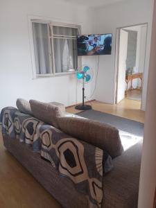 a living room with a couch with pillows on it at Home in Bellville, Cape Town in Victory Hill