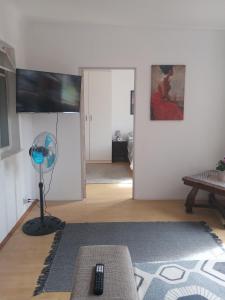 a living room with a fan and a room with a door at Home in Bellville, Cape Town in Victory Hill