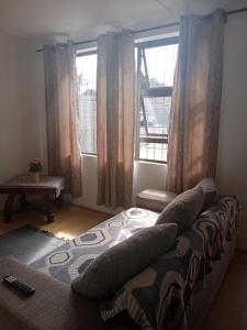 a bedroom with a bed with pillows and a window at Home in Bellville, Cape Town in Victory Hill