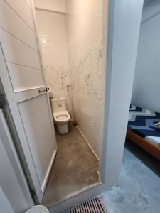 a small bathroom with a toilet in a room at ASHBURN'S TRANSIENT LA UNION - BAUANG, Self Service, Self Check-in, MOTORCYCLE Parking in Bauang +57 photos