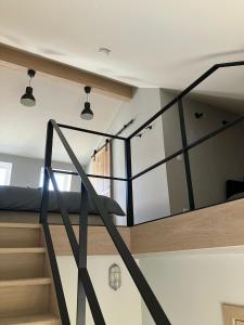 a room with a staircase and a bed in it at Huisje Emma in Tongeren