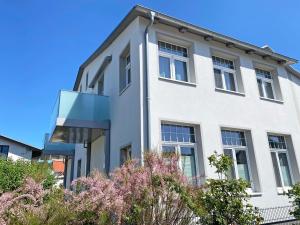 a white building with windows on the side of it at Haus Seestern in Thiessow