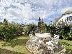 a white picnic table and chairs in a yard at Haus Seestern in Thiessow +107 photos