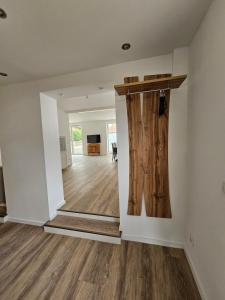 an empty room with a wooden door and a hallway at FeWo Safari - zwischen Holstentor & Ostsee in Lübeck