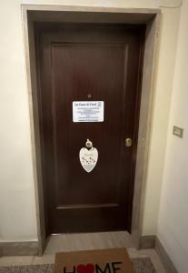 a brown door with a sign on it at La casa di Fred in Rome +18 photos